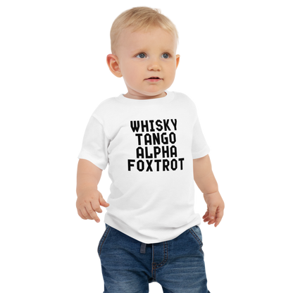"Whisky Tango Alpha Foxtrot" printed on a white baby jersey short sleeve tee worn by a male