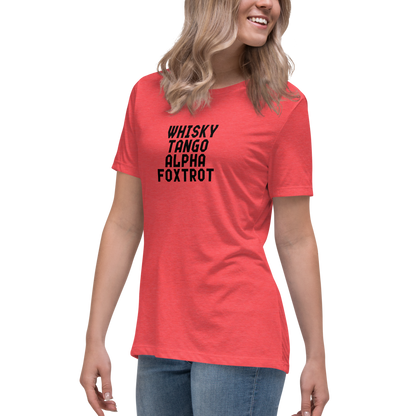 "Whisky Tango Alpha Foxtrot" printed on a heather red women's relaxed t-shirt worn by a female