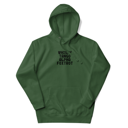 "Whisky Tango Alpha Foxtrot" printed on a forest green unisex hoodie laying on a flat surface with the hood up