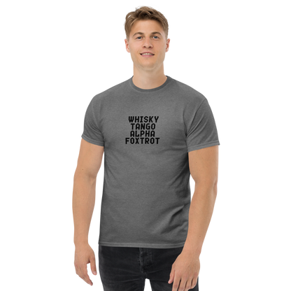 "Whisky Tango Alpha Foxtrot" printed on a graphite heather unisex classic tee worn by a male