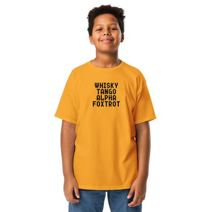 "Whisky Tango Alpha Foxtrot" printed on a gold youth classic tee worn by a male