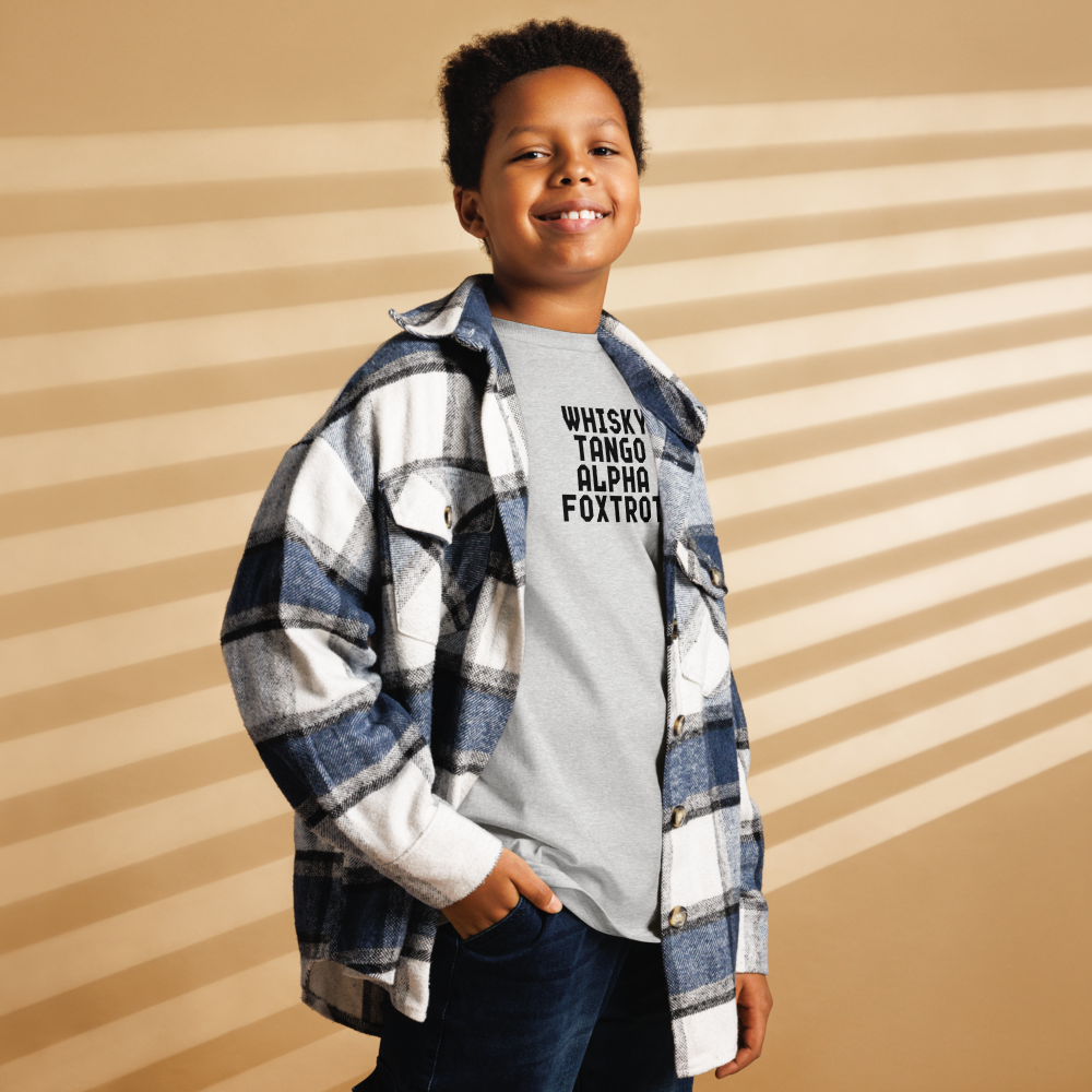 "Whisky Tango Alpha Foxtrot" printed on a sport grey youth classic tee worn by a male also wearing a jacket