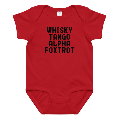 "Whisky Tango Alpha Foxtrot" printed on a red baby jersey bodysuit laying on a flat surface amongst other clothes