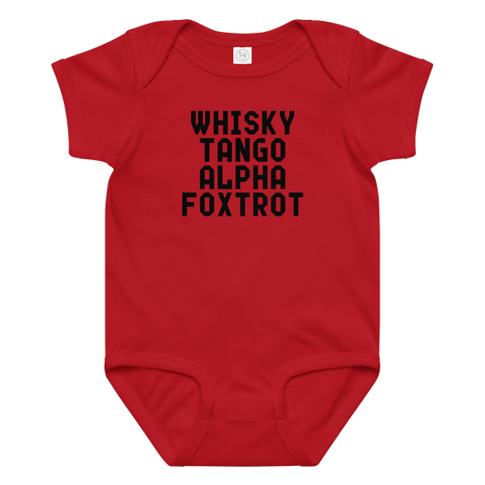 "Whisky Tango Alpha Foxtrot" printed on a red baby jersey bodysuit laying on a flat surface amongst other clothes