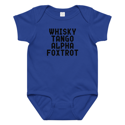 "Whisky Tango Alpha Foxtrot" printed on a royal baby jersey bodysuit laying on a flat surface amongst other clothes