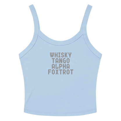 "Whisky Tango Alpha Foxtrot" printed on a solid baby blue blend women's micro-rib tanktop laying on a flat surface amongst sunglasses and shorts