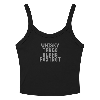 "Whisky Tango Alpha Foxtrot" printed on a solid black blend women's micro-rib tanktop laying on a flat surface amongst sunglasses and shorts