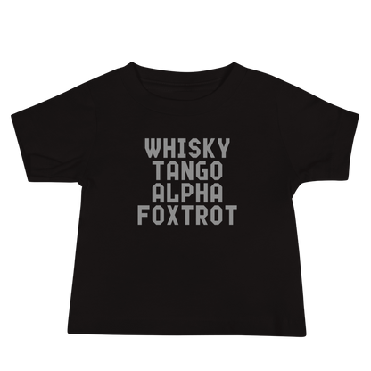 "Whisky Tango Alpha Foxtrot" printed on a black baby jersey short sleeve tee laying on a flat surface