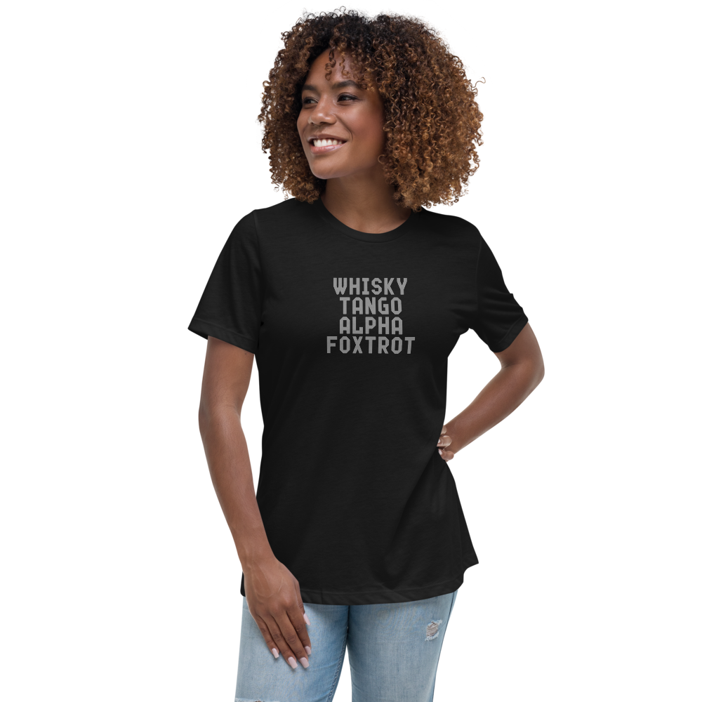 "Whisky Tango Alpha Foxtrot" printed on a black women's relaxed t-shirt worn by a female