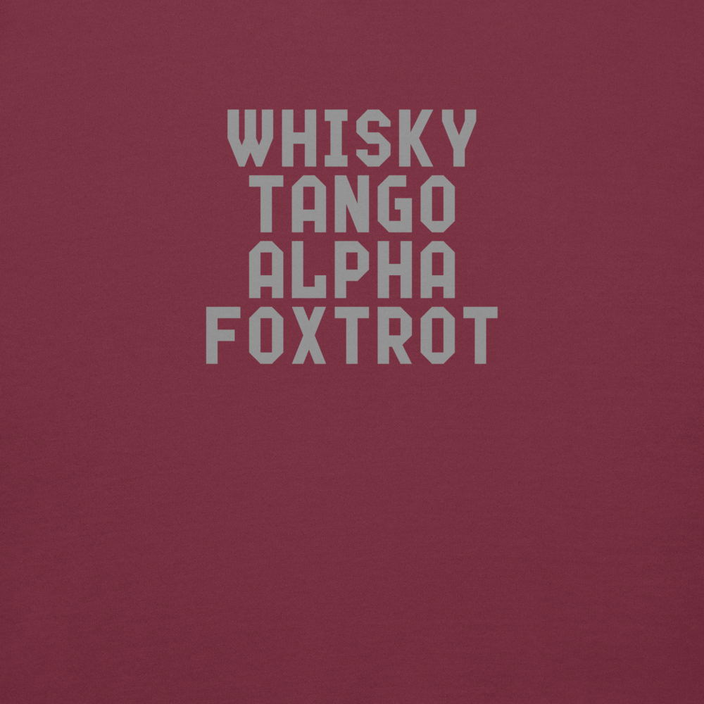 "Whisky Tango Alpha Foxtrot" printed on a maroon background