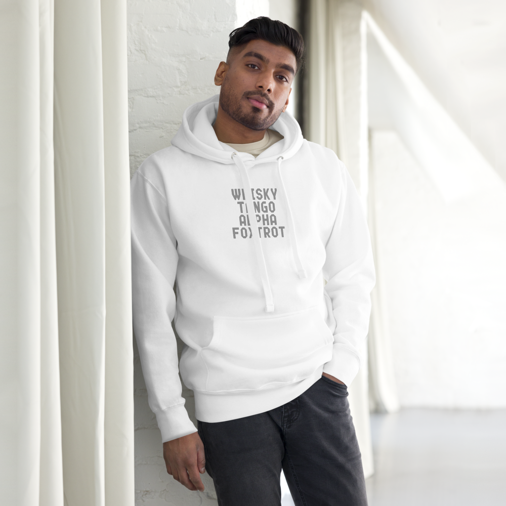 "Whisky Tango Alpha Foxtrot" printed on a white unisex hoodie worn by a male