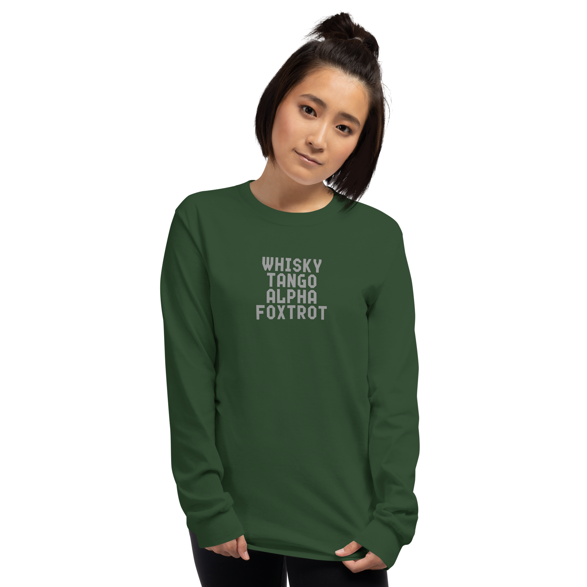 "Whisky Tango Alpha Foxtrot" printed on a forest green men's long sleeve shirt worn by a female