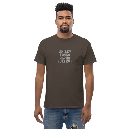 "Whisky Tango Alpha Foxtrot" printed on a dark chocolate unisex classic tee worn by a male
