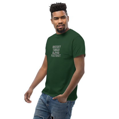"Whisky Tango Alpha Foxtrot" printed on a forest green unisex classic tee worn by a male