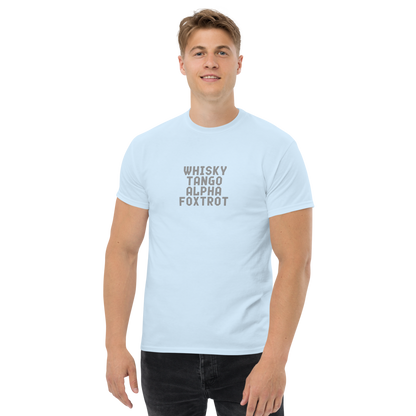 "Whisky Tango Alpha Foxtrot" printed on a light blue unisex classic tee worn by a male