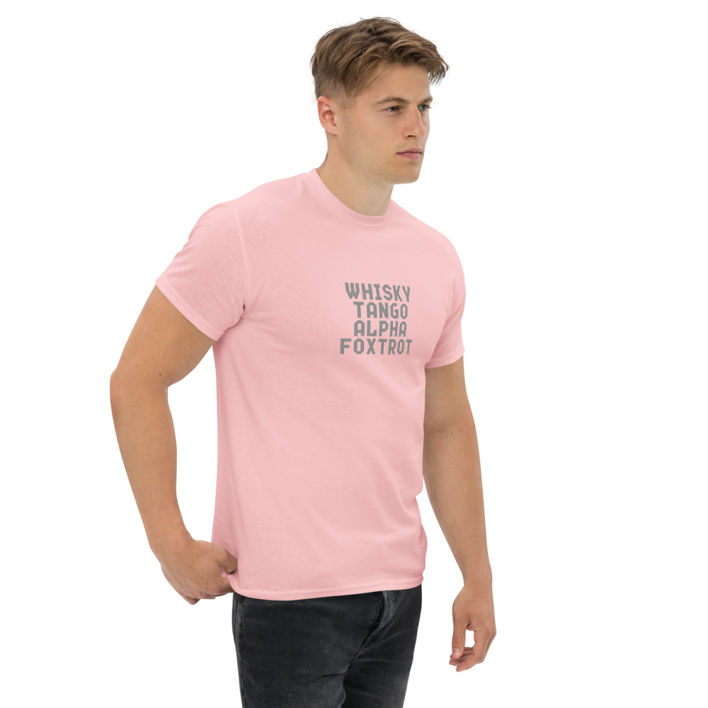 "Whisky Tango Alpha Foxtrot" printed on a light pink unisex classic tee worn by a male