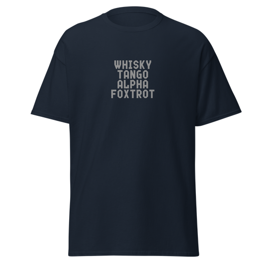 "Whisky Tango Alpha Foxtrot" printed on a navy unisex classic tee laying on a flat surface