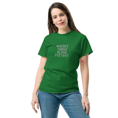 "Whisky Tango Alpha Foxtrot" printed on a turf green unisex classic tee worn by a female