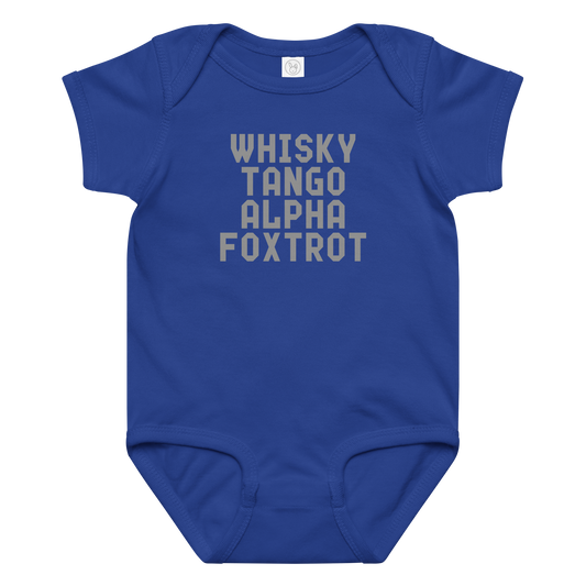 "Whisky Tango Alpha Foxtrot" printed on a royal baby jersey bodysuit laying on a flat surface amongst other clothes