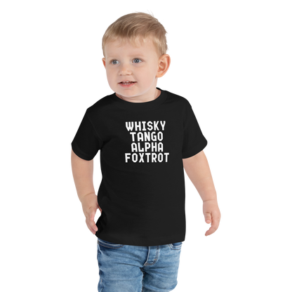 "Whisky Tango Alpha Foxtrot" printed on a black toddler short sleeve tee worn by a male