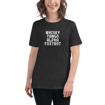 "Whisky Tango Alpha Foxtrot" printed on a dark grey heather women's relaxed t-shirt worn by a female
