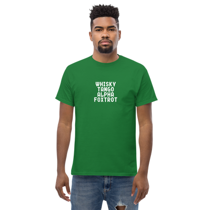 "Whisky Tango Alpha Foxtrot" printed on a turf green unisex classic tee worn by a male
