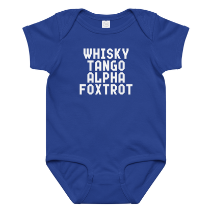 "Whisky Tango Alpha Foxtrot" printed on a royal baby jersey bodysuit laying on a flat surface amongst other clothes