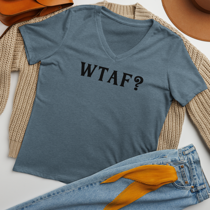 "WTAF?" printed on a heather slate women's relaxed v-neck t-shirt laying on a flat surface amongst other clothes
