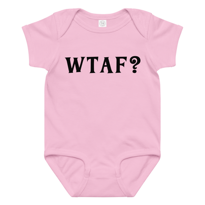 "WTAF?" printed on a pink baby jersey bodysuit laying on a flat surface amongst other clothes