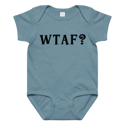"WTAF?" printed on a vintage indigo baby jersey bodysuit laying on a flat surface amongst other clothes