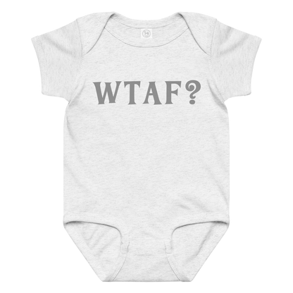 "WTAF?" printed on a ash baby jersey bodysuit laying on a flat surface amongst other clothes