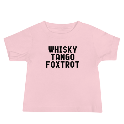 "Whisky Tango Foxtrot (What the f#ck)" printed on a pink baby jersey short sleeve tee laying on a flat surface