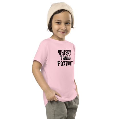 "Whisky Tango Foxtrot (What the f#ck)" printed on a pink toddler short sleeve tee worn by a male who is also wearing a knit cap