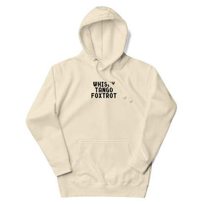 "Whisky Tango Foxtrot (What the f#ck)" printed on a bone unisex hoodie laying on a flat surface with the hood up