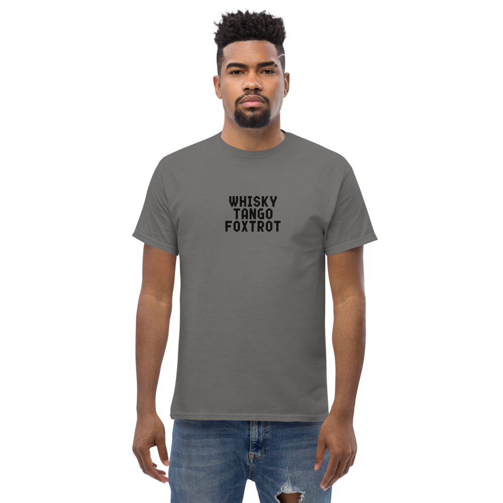 "Whisky Tango Foxtrot (What the f#ck)" printed on a charcoal unisex classic tee worn by a male