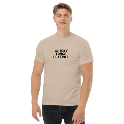 "Whisky Tango Foxtrot (What the f#ck)" printed on a sand unisex classic tee worn by a male