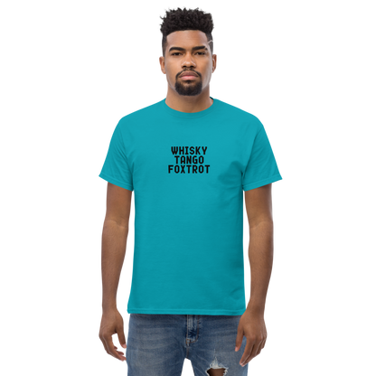 "Whisky Tango Foxtrot (What the f#ck)" printed on a tropical blue unisex classic tee worn by a male