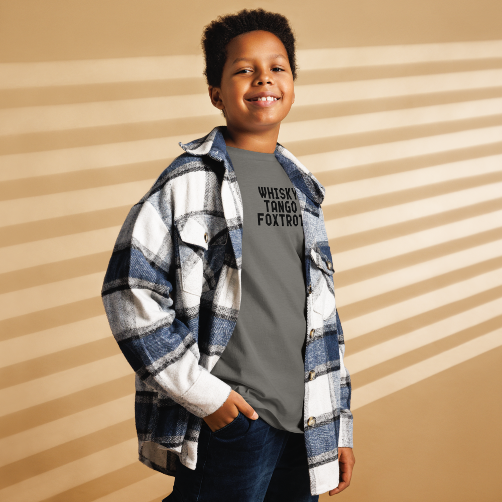 "Whisky Tango Foxtrot (What the f#ck)" printed on a charcoal youth classic tee worn by a male also wearing a jacket