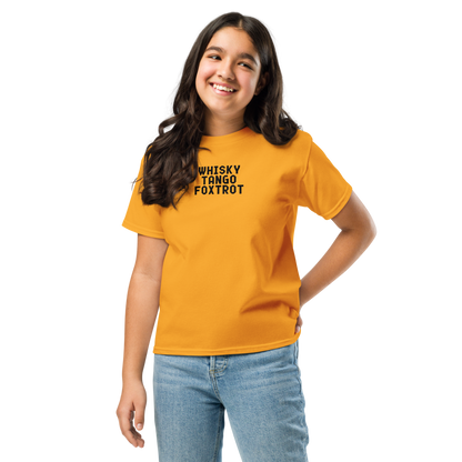 "Whisky Tango Foxtrot (What the f#ck)" printed on a gold youth classic tee worn by a female