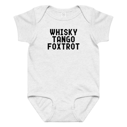 "Whisky Tango Foxtrot (What the f#ck)" printed on a ash baby jersey bodysuit laying on a flat surface amongst other clothes
