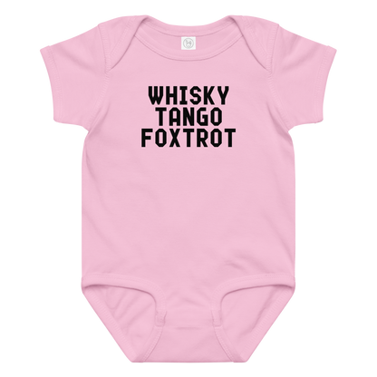 "Whisky Tango Foxtrot (What the f#ck)" printed on a pink baby jersey bodysuit laying on a flat surface amongst other clothes