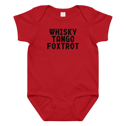 "Whisky Tango Foxtrot (What the f#ck)" printed on a red baby jersey bodysuit laying on a flat surface amongst other clothes