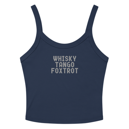 "Whisky Tango Foxtrot (What the f#ck)" printed on a solid navy blend women's micro-rib tanktop laying on a flat surface amongst sunglasses and shorts