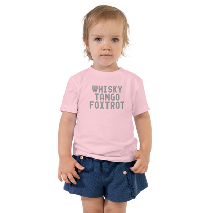 "Whisky Tango Foxtrot (What the f#ck)" printed on a pink toddler short sleeve tee worn by a female