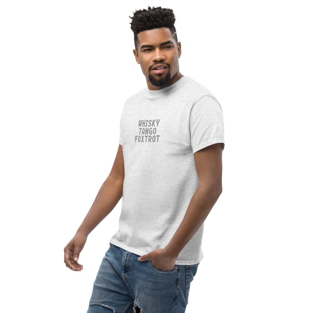 "Whisky Tango Foxtrot (What the f#ck)" printed on a ash unisex classic tee worn by a male
