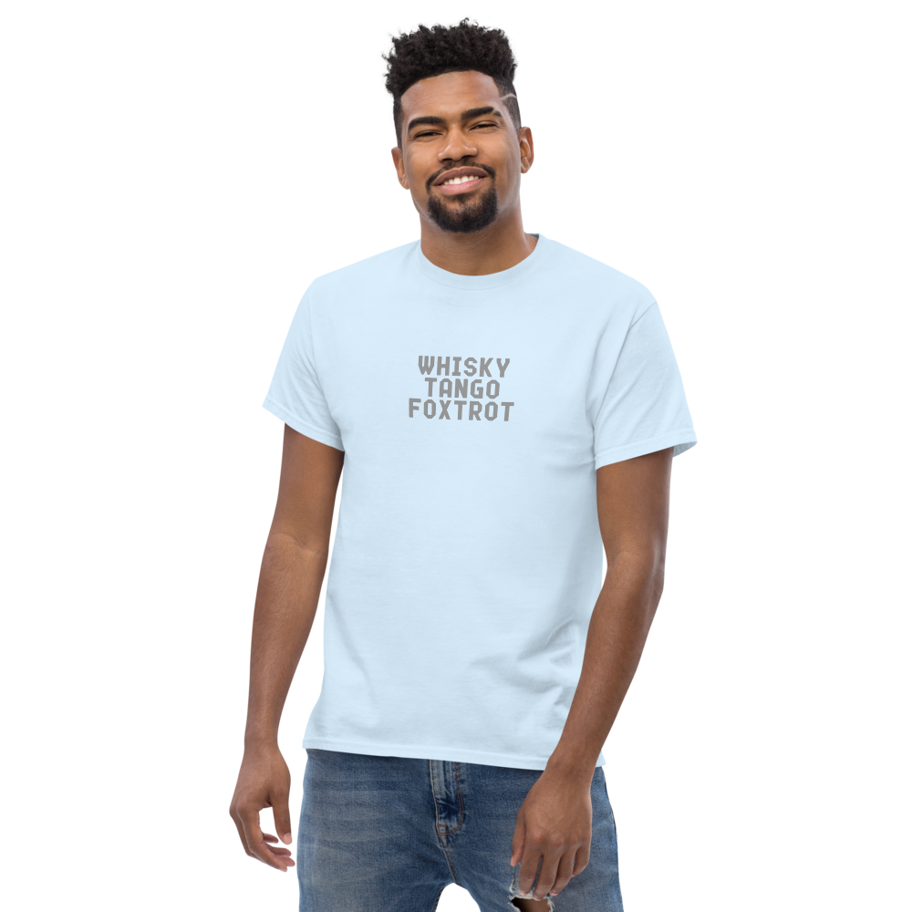 "Whisky Tango Foxtrot (What the f#ck)" printed on a light blue unisex classic tee worn by a male