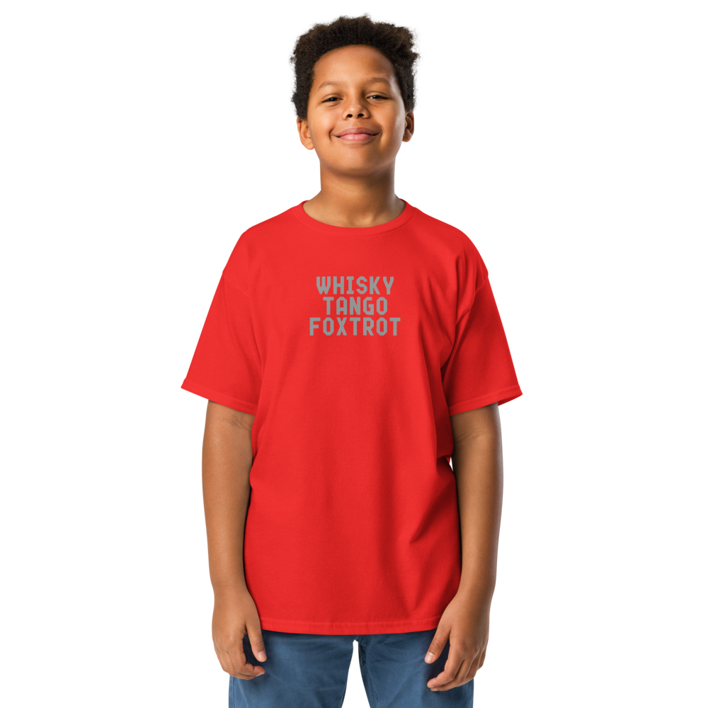 "Whisky Tango Foxtrot (What the f#ck)" printed on a red youth classic tee worn by a male