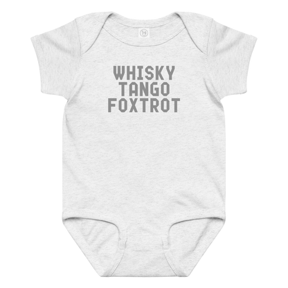 "Whisky Tango Foxtrot (What the f#ck)" printed on a ash baby jersey bodysuit laying on a flat surface amongst other clothes
