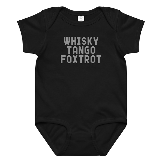 "Whisky Tango Foxtrot (What the f#ck)" printed on a black baby jersey bodysuit laying on a flat surface amongst other clothes