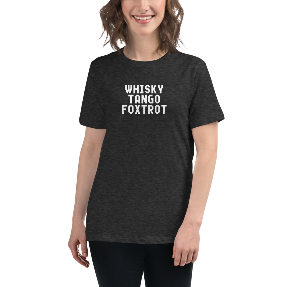 "Whisky Tango Foxtrot (What the f#ck)" printed on a dark grey heather women's relaxed t-shirt worn by a female